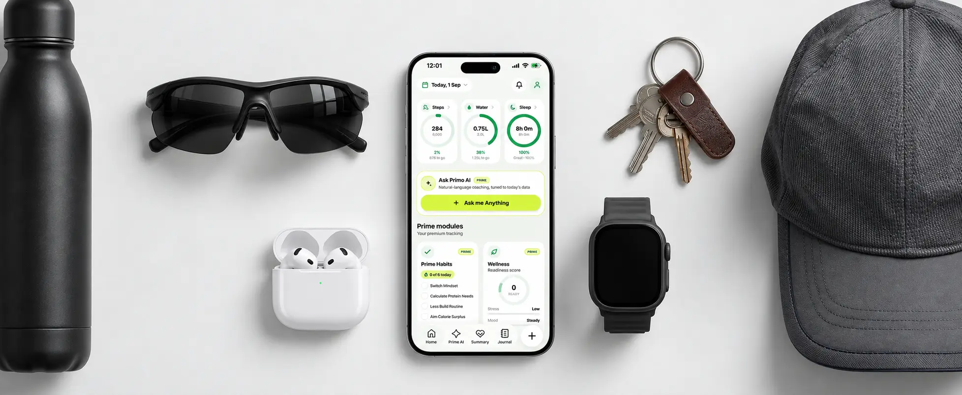 Primefit application displayed on iPhone alongside fitness gear and daily accessories
